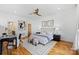 Well-lit main bedroom with hardwood floors, neutral decor, and modern ceiling fan at 914 Greenleaf Ave # A, Charlotte, NC 28202
