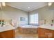 Well-lit bathroom features dual sinks, decorative tile, and a tiled corner bathtub under a window at 928 Thorn Ridge Ln, Clover, SC 29710