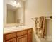 Bathroom with wood vanity, sink, and decorative mirror at 928 Thorn Ridge Ln, Clover, SC 29710