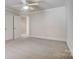 Neutral bedroom features a ceiling fan, plush carpet, and two paneled doors at 928 Thorn Ridge Ln, Clover, SC 29710