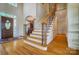 Welcoming foyer with hardwood floors and an elegant staircase with iron balusters at 928 Thorn Ridge Ln, Clover, SC 29710