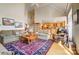 Spacious living room with large rug and staircase leading to the upper level, flowing into the kitchen at 928 Thorn Ridge Ln, Clover, SC 29710