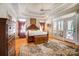 Spacious main bedroom with tray ceiling, ceiling fan, and access to a private balcony through French doors at 928 Thorn Ridge Ln, Clover, SC 29710
