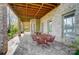 A covered patio with a red metal table and chairs offers outdoor seating and shade at 928 Thorn Ridge Ln, Clover, SC 29710