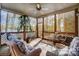 Cozy screened-in porch with wicker furniture, ceiling fan and relaxing atmosphere at 928 Thorn Ridge Ln, Clover, SC 29710