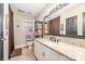 Bathroom boasts large mirror, granite counters, tan cabinets, and recessed lights at 9401 Elvis Dr, Charlotte, NC 28215