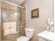 Neutral bathroom with shower, toilet, sink, framed art, and 'SORRELLS' towel at 9401 Elvis Dr, Charlotte, NC 28215