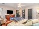 Spacious bedroom with a ceiling fan, hardwood floors, and view to the bathroom at 9401 Elvis Dr, Charlotte, NC 28215