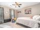 Cozy bedroom with light carpet, ceiling fan, bed, and painting of a cow at 9401 Elvis Dr, Charlotte, NC 28215