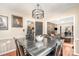 Open dining room with a large table, decorative lighting fixture, and views to the kitchen and living room at 9401 Elvis Dr, Charlotte, NC 28215