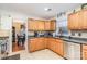 Well-lit kitchen with wooden cabinets, stainless steel appliances, and a view into the adjacent dining area at 9401 Elvis Dr, Charlotte, NC 28215