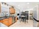 Bright kitchen featuring wood cabinets, stainless steel appliances and casual dining at 9401 Elvis Dr, Charlotte, NC 28215