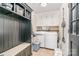 Functional laundry room with washer, dryer, shelving, and storage at 9401 Elvis Dr, Charlotte, NC 28215