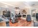 Bright living room with a fireplace, ceiling fan, hardwood floors, and comfortable seating at 9401 Elvis Dr, Charlotte, NC 28215