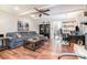 Cozy living room featuring a plush gray sofa, fireplace and a view to the kitchen at 9401 Elvis Dr, Charlotte, NC 28215