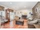 Cozy living room with hardwood floors, comfortable seating, and a decorative wood accent wall at 9401 Elvis Dr, Charlotte, NC 28215