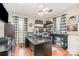 Office features dark wood floors, multiple windows, dark desk and furnishings, and ceiling fan at 9401 Elvis Dr, Charlotte, NC 28215