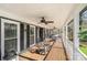 Expansive covered porch with multiple rocking chairs, ideal for outdoor relaxation at 9401 Elvis Dr, Charlotte, NC 28215