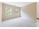 Neutral bedroom with wall to wall carpet features two windows with natural light at 9423 Fairmead Dr, Charlotte, NC 28269