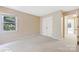 Bedroom with neutral walls and carpet features window and closet at 9423 Fairmead Dr, Charlotte, NC 28269