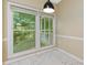 Dining area featuring large windows and light-colored tile floors at 9423 Fairmead Dr, Charlotte, NC 28269