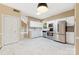 Bright kitchen with stainless appliances, white cabinets and light colored tile flooring at 9423 Fairmead Dr, Charlotte, NC 28269