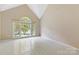 Bright living room boasts vaulted ceiling, large windows, and light colored flooring at 9423 Fairmead Dr, Charlotte, NC 28269