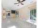 Open-concept living room with access to the kitchen and lots of natural light at 9423 Fairmead Dr, Charlotte, NC 28269
