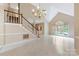 Inviting living room featuring a staircase, chandelier and a window at 9423 Fairmead Dr, Charlotte, NC 28269