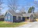 Charming blue home featuring a quaint front porch and well-maintained lawn at 9930 Sardis Oaks Rd, Charlotte, NC 28270