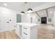 Open concept kitchen with island, view into living room with vaulted ceilings and fireplace at 9930 Sardis Oaks Rd, Charlotte, NC 28270