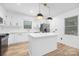 Modern kitchen with stainless steel appliances, island, and white cabinetry at 9930 Sardis Oaks Rd, Charlotte, NC 28270