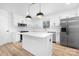 Bright kitchen with stainless steel appliances, island, and white cabinetry at 9930 Sardis Oaks Rd, Charlotte, NC 28270