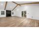 Bright living room with fireplace, slider door access, and natural wood floors at 9930 Sardis Oaks Rd, Charlotte, NC 28270