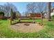 A landscaped backyard features a stone firepit area with seating and string lights at 101 Woodvale Cir, Lincolnton, NC 28092