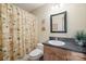 Cozy bathroom featuring a vanity with a dark countertop, a toilet, and a shower with a patterned curtain at 101 Woodvale Cir, Lincolnton, NC 28092