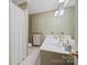 Well-lit bathroom featuring wallpaper, tiled floors, and a shower and tub combination at 101 Woodvale Cir, Lincolnton, NC 28092