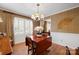 Formal dining room with decorative chandelier, wood floors, and elegant window treatments at 101 Woodvale Cir, Lincolnton, NC 28092