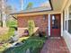 Charming entrance with brick facade, water feature, bench, and well-manicured landscaping at 101 Woodvale Cir, Lincolnton, NC 28092