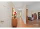 Hallway featuring hardwood floors, white trim, and a glimpse into a comfortably furnished sitting room at 101 Woodvale Cir, Lincolnton, NC 28092