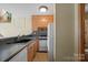 Traditional kitchen featuring wooden cabinets, black countertops, and modern appliances at 101 Woodvale Cir, Lincolnton, NC 28092