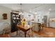 Well-lit kitchen featuring white cabinetry, stainless steel appliances, an island and a dining table at 101 Woodvale Cir, Lincolnton, NC 28092
