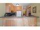 Functional kitchen featuring a breakfast bar, microwave, fridge, and wood cabinetry at 101 Woodvale Cir, Lincolnton, NC 28092