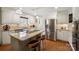Bright kitchen with white cabinets, granite countertops, stainless steel appliances, and a spacious island at 101 Woodvale Cir, Lincolnton, NC 28092