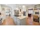 Open concept kitchen features stainless steel appliances, granite counters, and white cabinetry at 101 Woodvale Cir, Lincolnton, NC 28092