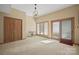Bright living room with large windows, neutral carpet, and a decorative light fixture at 101 Woodvale Cir, Lincolnton, NC 28092