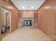 Wood-paneled living room with a stone fireplace and built-in shelving at 101 Woodvale Cir, Lincolnton, NC 28092