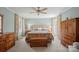 Spacious primary bedroom with carpeted floors, ceiling fan, and lots of natural light at 101 Woodvale Cir, Lincolnton, NC 28092