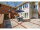Backyard brick patio featuring an outdoor dining area with a grill and views of the home's architecture at 101 Woodvale Cir, Lincolnton, NC 28092