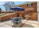 Outdoor patio with brick accents, seating, grill, and a blue umbrella at 101 Woodvale Cir, Lincolnton, NC 28092